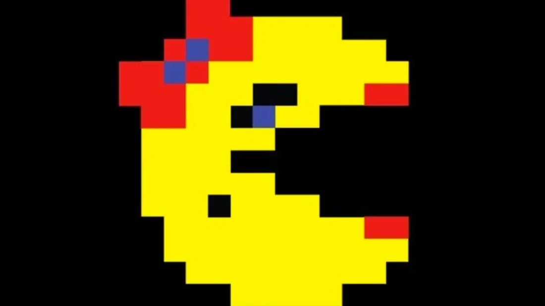 Ms. Pac-Man showing the distinctive design with red bow, beauty mark, and features that differentiate her from the original Pac-Man